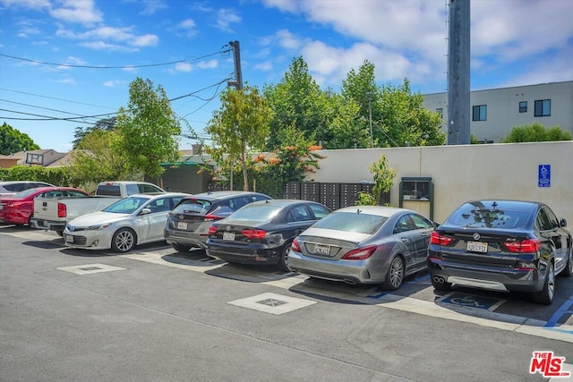 view of vehicle parking featuring a mail area