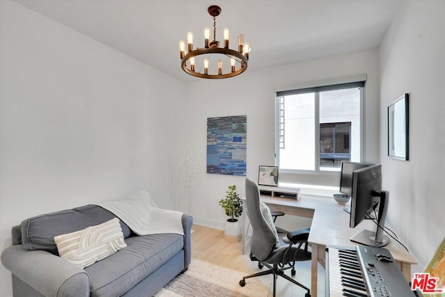 office space with an inviting chandelier and light wood-type flooring