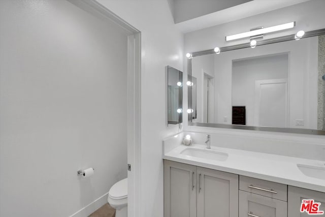 bathroom featuring toilet and vanity