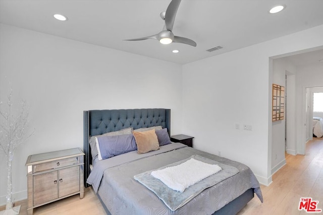 bedroom with ceiling fan and light hardwood / wood-style floors