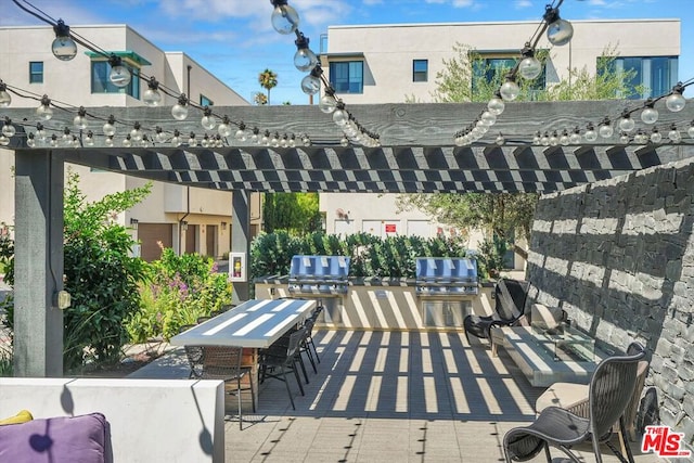 view of patio / terrace featuring an outdoor bar and area for grilling