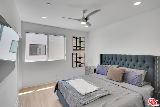 bedroom with ceiling fan and light hardwood / wood-style flooring