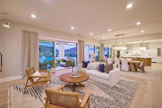 living room with light hardwood / wood-style flooring and a mountain view