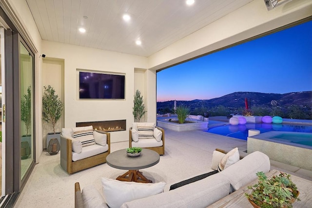 view of patio / terrace with a pool with hot tub and an outdoor hangout area