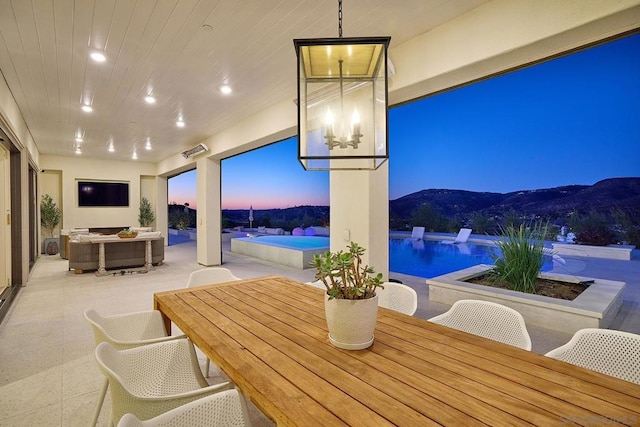 dining space featuring an inviting chandelier and a mountain view