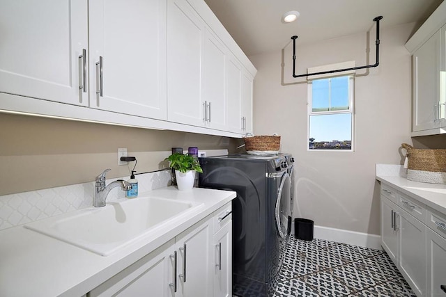 washroom with independent washer and dryer, cabinets, and sink