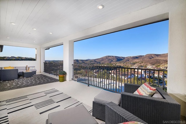 view of patio / terrace featuring a balcony, a mountain view, and outdoor lounge area