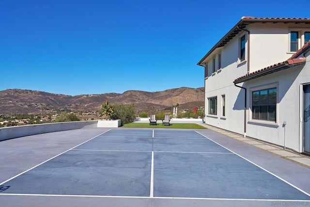 view of tennis court with a mountain view