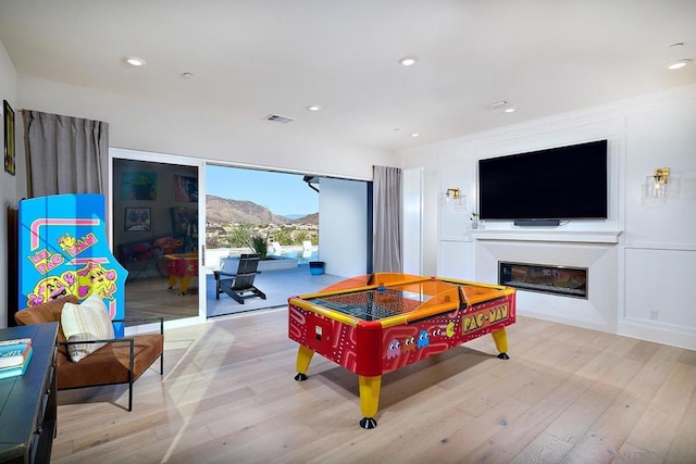 recreation room featuring light hardwood / wood-style flooring