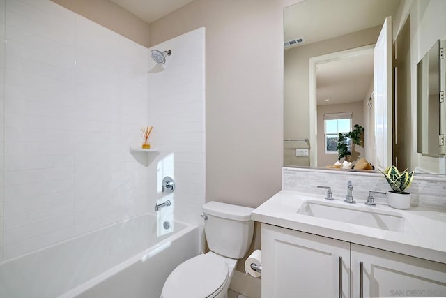 full bathroom with toilet, tiled shower / bath combo, and vanity