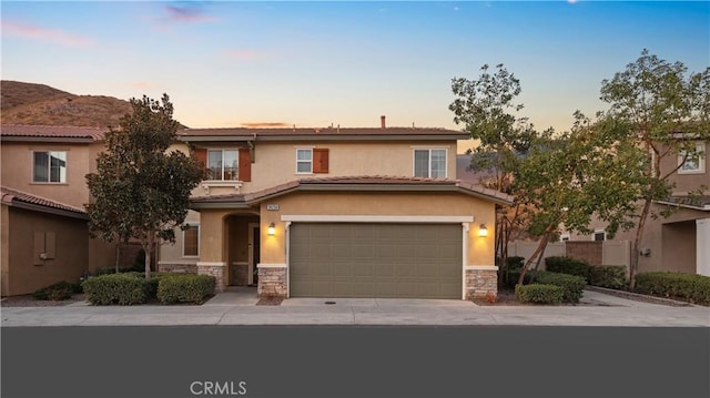 view of front of property featuring a garage and a mountain view