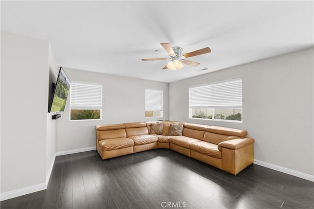 living room with dark hardwood / wood-style flooring, plenty of natural light, and ceiling fan