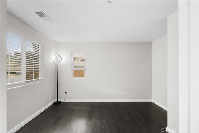 unfurnished room with dark hardwood / wood-style flooring