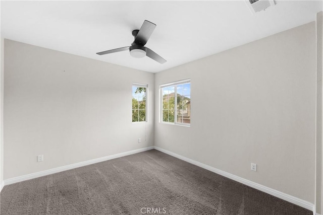 carpeted spare room featuring ceiling fan