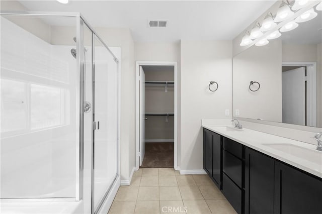 bathroom with tile patterned flooring, an enclosed shower, and vanity