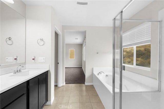 bathroom featuring vanity, independent shower and bath, and tile patterned flooring