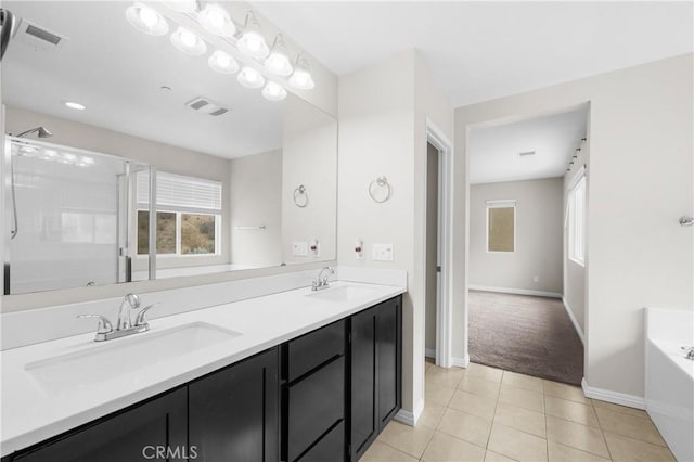 bathroom with tile patterned flooring, vanity, plenty of natural light, and separate shower and tub