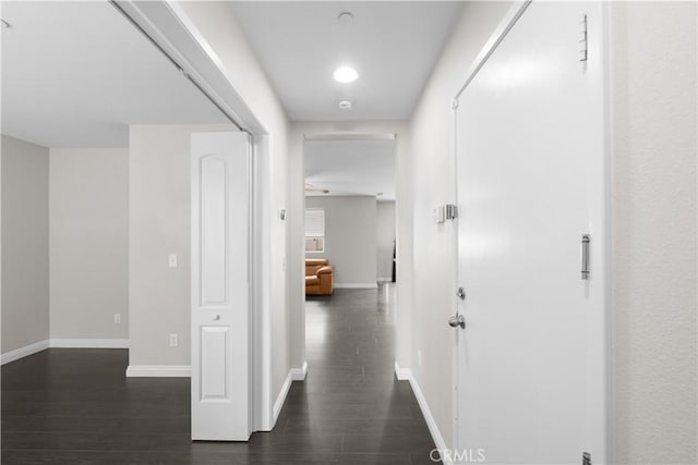 corridor featuring dark wood-type flooring