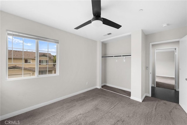 unfurnished bedroom featuring ceiling fan, carpet, and a closet