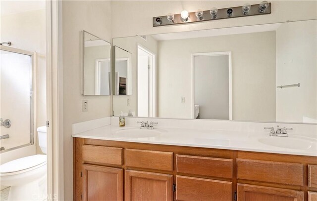 full bathroom featuring  shower combination, vanity, and toilet