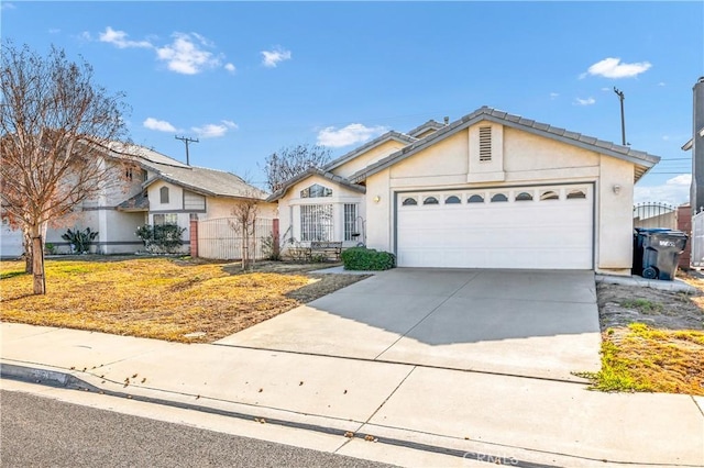 view of front of property featuring a garage, driveway, and stucco siding