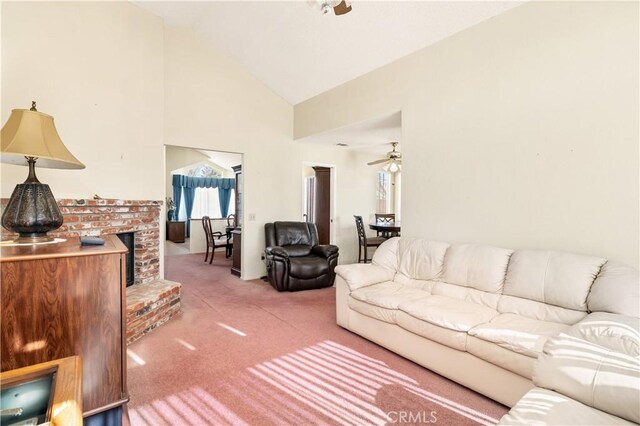 carpeted living room featuring high vaulted ceiling, a brick fireplace, and ceiling fan