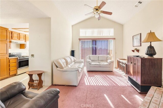 living room featuring lofted ceiling, ceiling fan, and light carpet