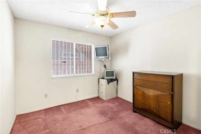 unfurnished bedroom with a textured ceiling, ceiling fan, and carpet flooring