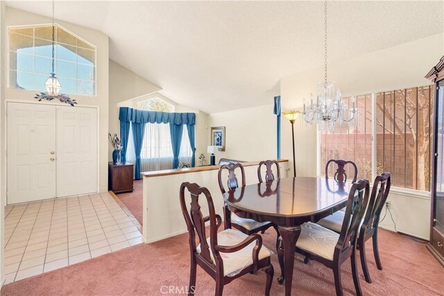 dining room featuring lofted ceiling, tile patterned floors, and a notable chandelier