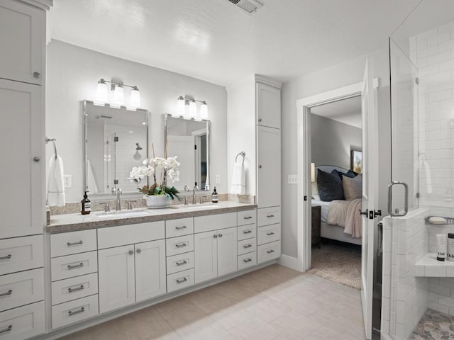 bathroom with walk in shower and vanity