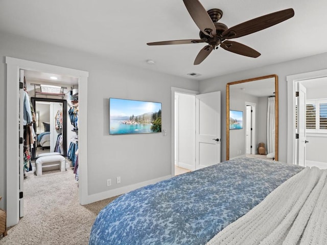 carpeted bedroom with ceiling fan and a closet