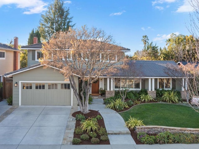 view of front of home with a garage and a front yard