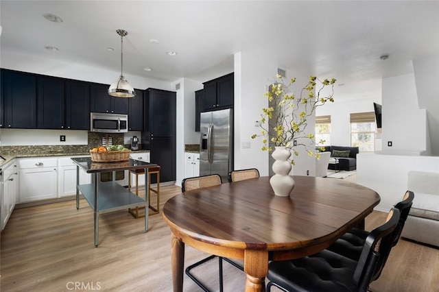 dining area with light hardwood / wood-style flooring