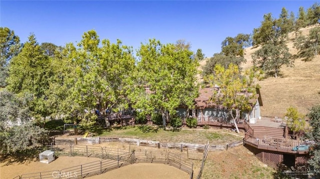 view of yard with a deck and a rural view