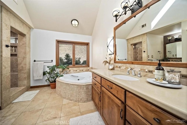 bathroom featuring plus walk in shower, lofted ceiling, tile patterned floors, and vanity