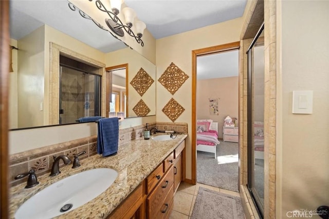 bathroom featuring vanity, tile patterned flooring, a notable chandelier, decorative backsplash, and a shower with door