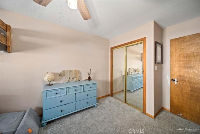 carpeted bedroom featuring a closet and ceiling fan