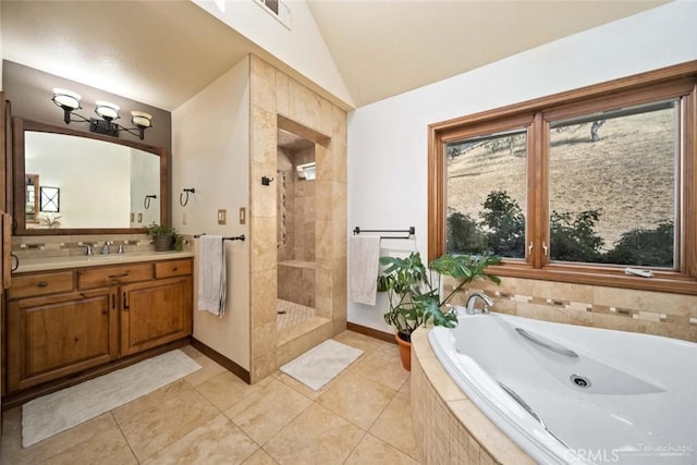 bathroom featuring lofted ceiling, vanity, tile patterned flooring, and plus walk in shower