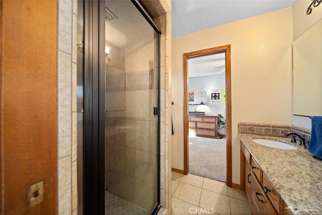 bathroom with walk in shower, vanity, and tile patterned flooring