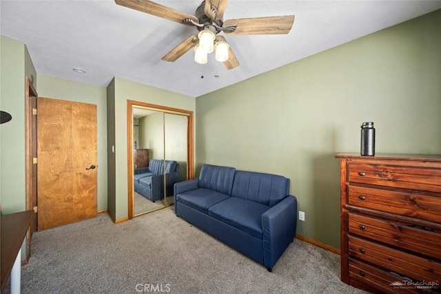 sitting room featuring light carpet and ceiling fan