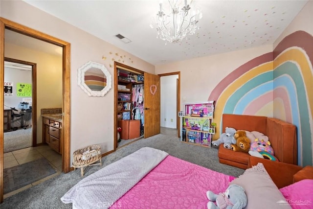 carpeted bedroom with a closet and an inviting chandelier