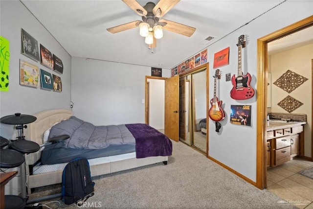 carpeted bedroom with ceiling fan and a closet