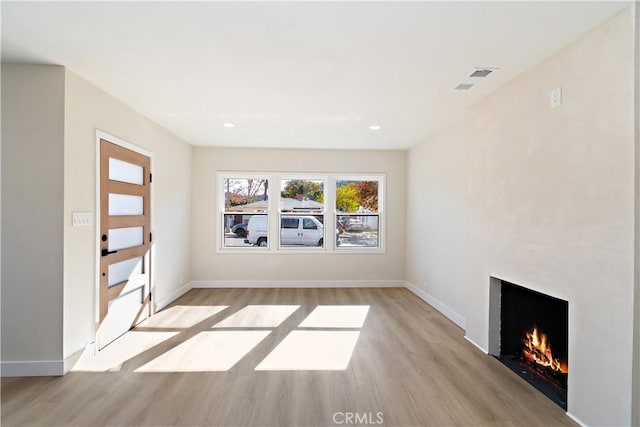 unfurnished living room with light wood-type flooring