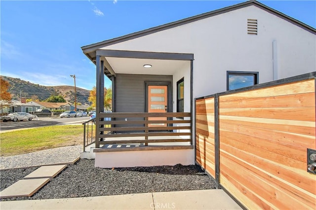 view of side of property with a porch and a mountain view