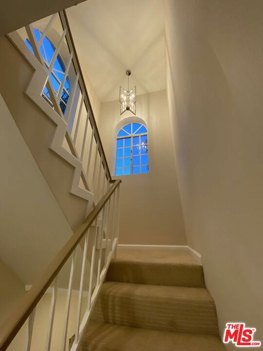 stairway with a chandelier