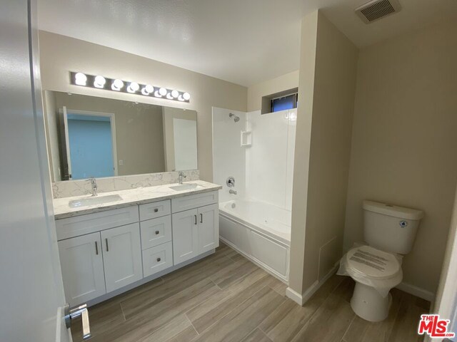 full bathroom featuring toilet, vanity, and shower / bathing tub combination