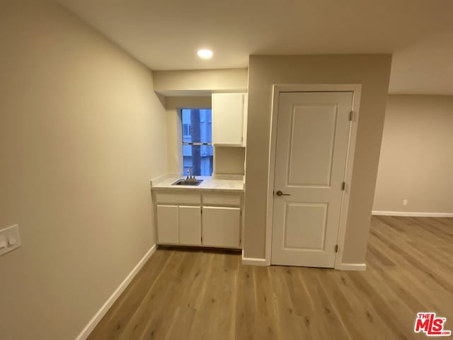 hall featuring sink and light hardwood / wood-style flooring