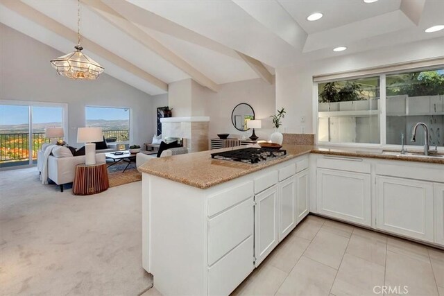 kitchen featuring white cabinets, pendant lighting, and open floor plan