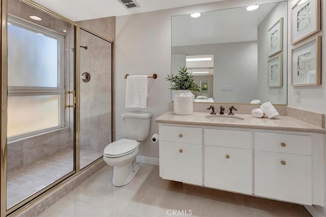 full bath featuring toilet, a stall shower, vanity, and baseboards