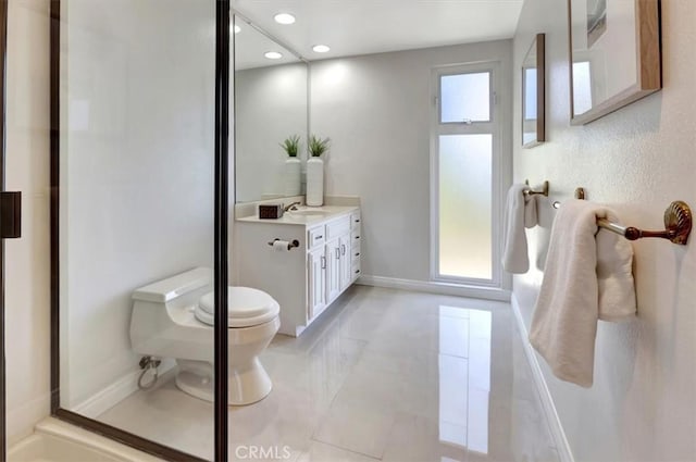 bathroom featuring recessed lighting, toilet, vanity, baseboards, and tile patterned floors